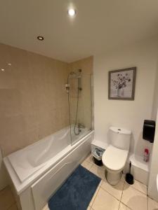 a bathroom with a white tub and a toilet at Superb 3-Bed Residence Airport in Dublin