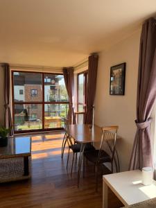 a dining room with a table and chairs and a window at Superb 3-Bed Residence Airport in Dublin