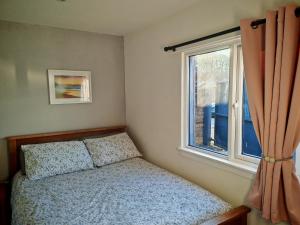 a bedroom with a bed and a window at Full Pint in Tain