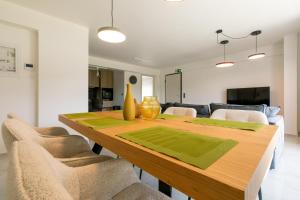 a dining room with a wooden table and chairs at Breeze Concept Villa in Drosia