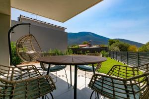 a table and chairs on a patio with a view at Breeze Concept Villa in Drosia
