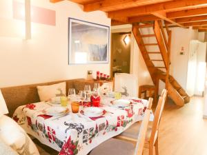 a dining room table with a red and white table cloth at Residence Villa Artic in Campitello di Fassa