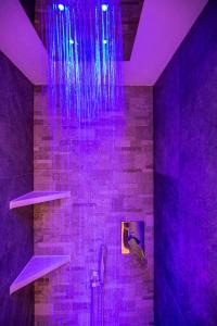 a purple bathroom with a shower with purple lights at Residence Villa Artic in Campitello di Fassa +73 photos