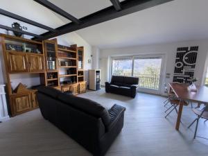 a living room with a couch and a table at Lario Panorama in Colico