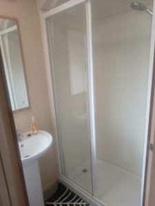 a bathroom with a shower and a sink at Sunningdale comfy suite in Tattershall