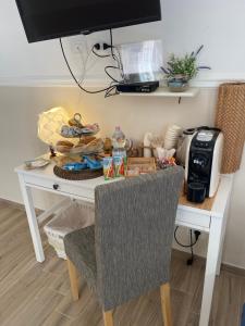 a white desk with a plate of food on it at B&B La Torre in Realmonte
