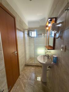 a bathroom with a sink and a shower at Villa Georgia beach in Neos Marmaras +72 photos