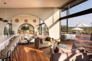 a living room with couches and a bar at 18 On The Hill in Mica