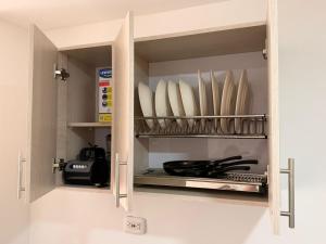 a cupboard filled with lots of plates and bowls at San gil plaza confort in San Gil