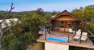a house with a deck and a swimming pool at 18 On The Hill in Mica