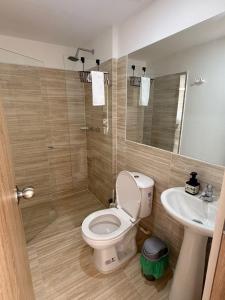 a bathroom with a toilet and a sink at San gil plaza confort in San Gil +9 photos