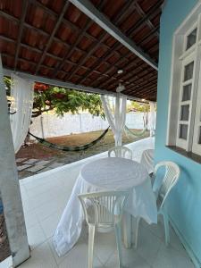 a white table and chairs on a patio at Villa Bárbara residência in Aracaju +28 photos
