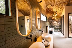 a bathroom with two sinks and two mirrors at 18 On The Hill in Mica