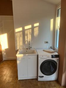 a kitchen with a washing machine and a sink at Corte Galassi in Torsa