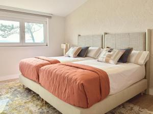two large beds in a bedroom with a window at Beachfront Luxury Villa in O Grove