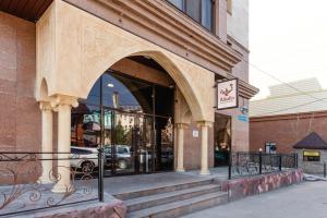 a store front with an archway in a building at Alladin Capsule Hotel in Almaty