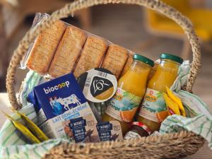 a basket filled with drinks and crackers and condiments at A la folie in Folligny +11 photos