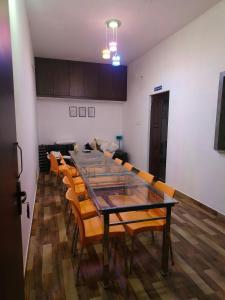 a dining room with a long table and chairs at Prysm Homestay - Kotagiri in Kotagiri