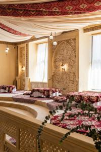 a bedroom with two beds with red pillows at Alladin Capsule Hotel in Almaty +51 photos