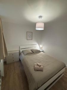 a bedroom with a bed with a towel on it at charmant appartement 4 pers hyper centre, au calme in Rouen