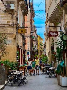 a group of people walking down a city street at Antica Dimora in Taranto