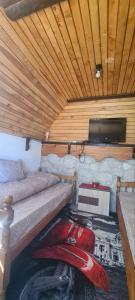 a room with two beds and a flat screen tv at Vikendica Pejovic in Žabljak