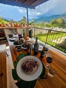 a table with a plate of food on top of it at Villa Amaranto Oxapampa in Oxapampa