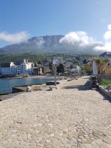 a stone walkway with a mountain in the background at Vila Familija in Dobra Voda
