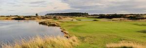 a view of a golf course with a pond at Full Pint in Tain