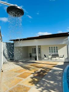 a water fountain on the side of a building at Casa da Lua in Barreirinhas