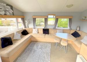 a living room with a couch and a table at 609 Sycamore Forest in Newquay