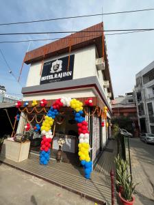 a store with a bunch of balloons in front of it at Hotel raj inn in Lucknow