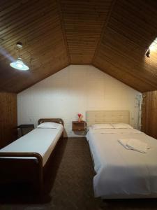 a bedroom with two beds in a room at Holiday Guest-House in Përmet