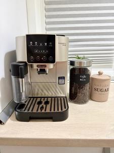 a coffee maker sitting on top of a counter at Cozy 2Rooms in Popeşti-Leordeni +4 photos