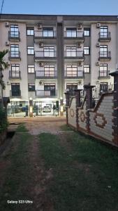 a large apartment building with a courtyard in front of it at Lita Residence in Yaoundé