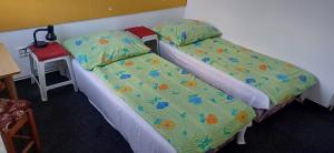 two beds sitting next to each other in a room at Penzion Mirja in Hodkovice