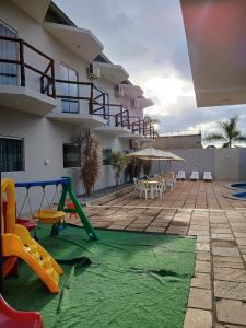 a patio with a play area with a playground at Pousada Monte das Colinas in Montezuma