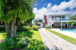 a house with a swimming pool and a tree at Ria's Rest Self Catering Flatlet in Sedgefield
