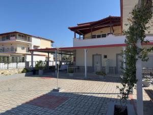 a building with a courtyard in front of it at Villa Georgia beach in Neos Marmaras