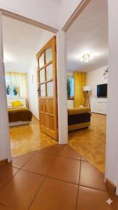 a room with a room with two beds and a door at Apartament Motylek in Hajnówka