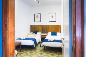 a group of four beds in a room at Casa Arbós Casa rural a Arbeca, les Garrigues in Arbeca