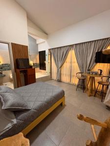 a bedroom with a bed and a table and chairs at Hotel Campestre Alma Nativa in Calarcá +71 photos