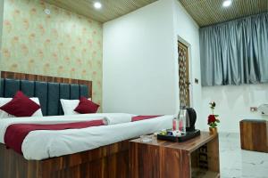 a bedroom with a large bed with red pillows at Hotel raj inn in Lucknow