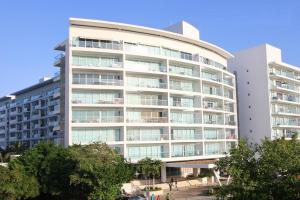 a large white building with trees in front of it at Morros 3 Frente al Mar - Piscinas y Jacuzzi in Cartagena de Indias