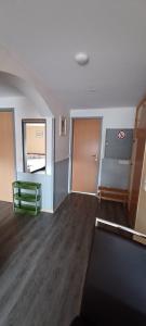 an empty room with a staircase and a mirror at Ferienwohnung Rita in Aschendorf