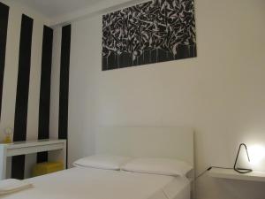 a room with a bed and a picture on the wall at Old Town Guest House in Genoa