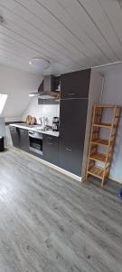 a kitchen with a counter and a ladder in a room at Ferienwohnung Rita in Aschendorf
