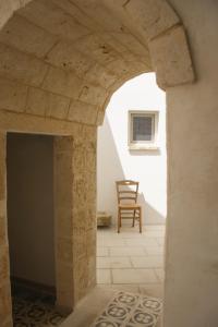 an archway leading into a room with a chair at Corte Sant'Oronzo in Diso