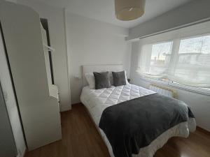 a bedroom with a bed and a window at La Costa Suite in Gijón