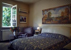 a bedroom with a bed and a chair and a window at Small Paradise Palermo in Palermo +36 photos